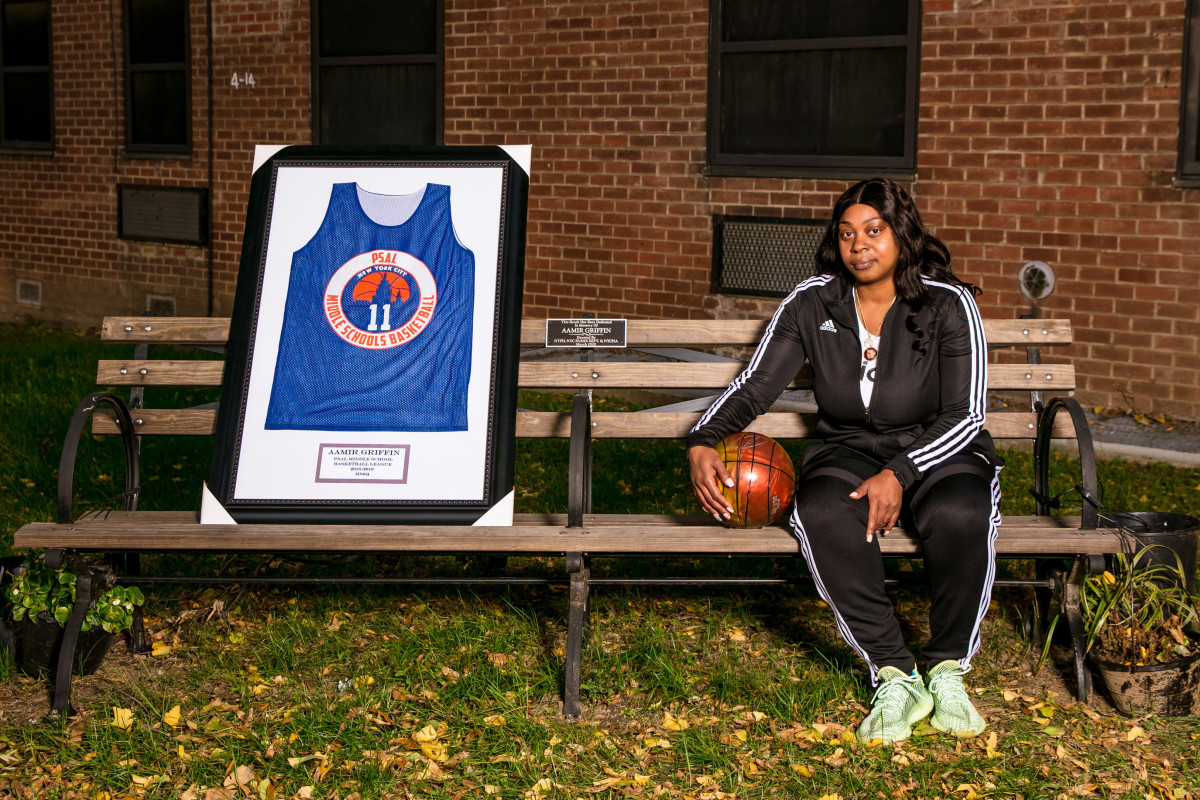 Aamir Griffin's mother, Shanequa, sits on a bench dedicated to her son.